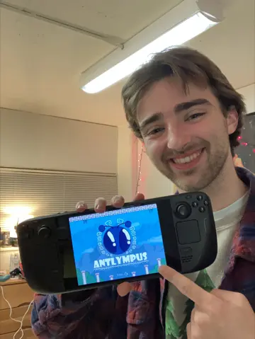 Gregory Walker holding the Steam Deck with Antlympus on screen